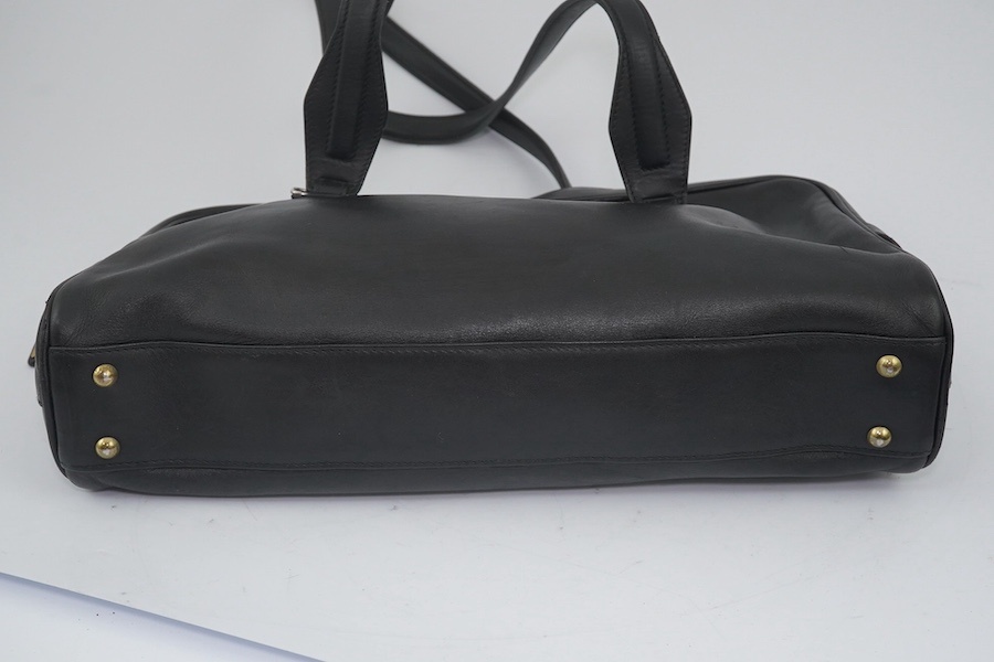 Three vintage Gucci handbags, two canvas blue GG monogram and the other black leather